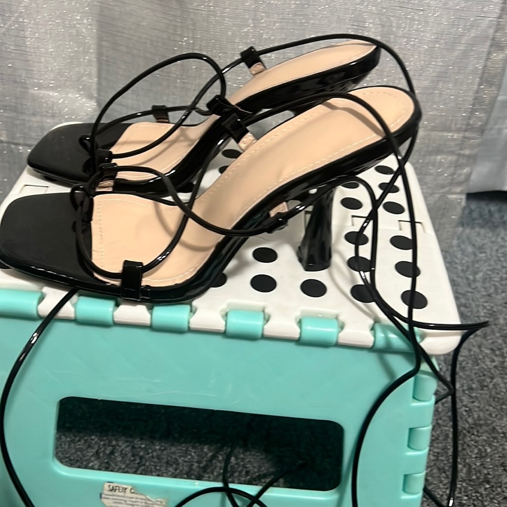 Black heels tie up leg.